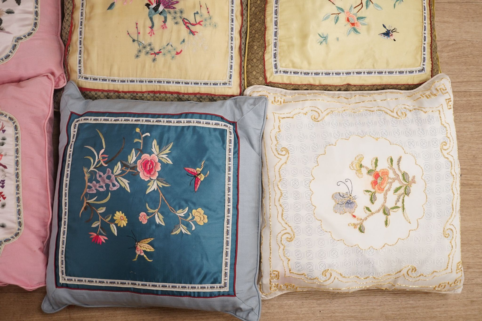 Three pairs of Chinese silk embroidered cushions and a cushion